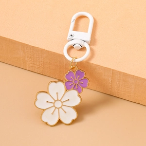 Detail view of double enamel cherry blossom pendants with white lobster clasp