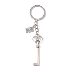 Detail view of silver heart key keychain with crystal letter E charm and vintage texture