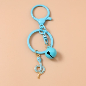 Close-up of blue enamel snake keychain with matching bell and lobster clasp detail