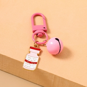 Close-up of pink medical theme keychain with enamel medicine bottle and bell detail