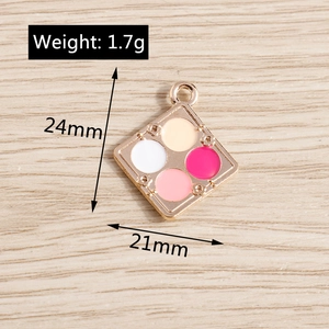 Detail of 24x21mm diamond enamel blush palette pendants with tiny flower relief on wood