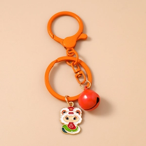 Detail of orange bell keychain with white enamel snake charm and Chinese lucky character