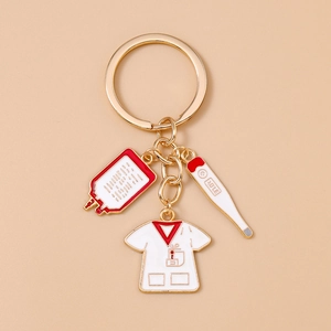 Detail view of medical theme keychain with blood bag, thermometer and nurse uniform charms