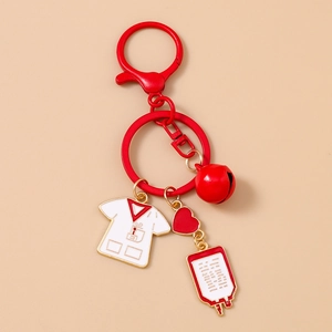 Detailed medical keychain with red nursing scrubs, red heart, bell, and IV drip bag charms
