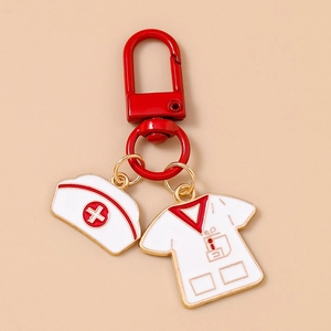 Detail of red nurse uniform and cap charms on a medical themed metal keychain
