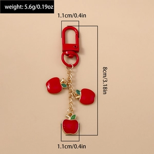 Detailed view of red apple keychain showing size dimensions and lightweight 5.6g weight