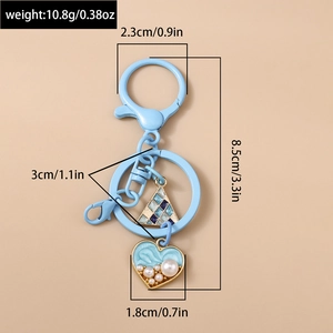 Detail view of light blue heart keychain with faux pearls and dimensions info