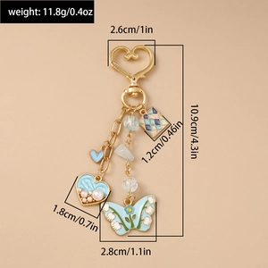 Detail showing dimensions and components of blue heart butterfly keychain in gold finish