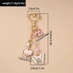 Detailed view of pink butterfly and heart charm keychain with size and weight specs