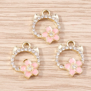 Three pieces of gold hollow cat head pendants with pink cherry blossom and crystals