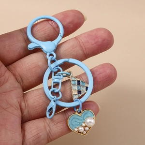 Blue heart keychain with pearls and checkered triangle charm for women backpack