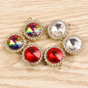 Détail de breloques rondes en strass avec pierres colorées et base en alliage doré