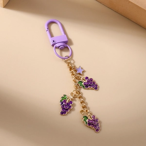 Detail view of purple grape cluster keychain with gold-tone chain and star charm