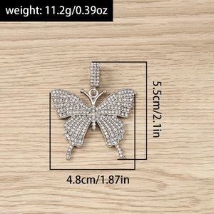 Detailed view of silver butterfly charms with rhinestones measuring 5.5cm by 4.8cm