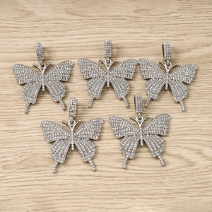 Set of sparkling butterfly pendants with silver metal and clear rhinestones on wood