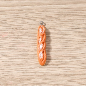 Macro detail of artificial baguette pendant with realistic texture and silver hook