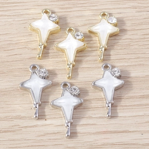 Detailed view of rhinestone four-pointed star charms in gold and silver plating