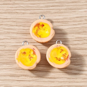 Detailed macro view of three miniature egg tart resin charms for DIY jewelry making crafts