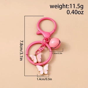 Detailed view of pink butterfly keychain with bell and dimension specs on pink background