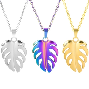 Detailed view of monstera leaf pendants in gold, silver, and rainbow steel finish