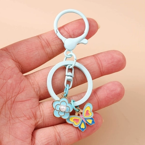 Light blue enamel flower and butterfly keychain with pearl center and horseshoe buckle