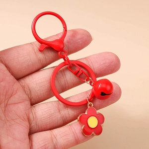 Red bell keychain with floral pendant featuring lobster clasp and vibrant heart motif