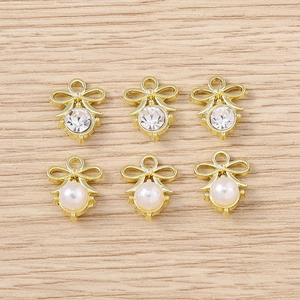 Detail of 6pcs gold-plated bow pendants with white pearls and zircons for DIY jewelry