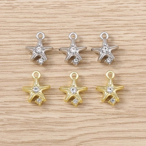 Detailed view of rhinestone starfish charms in gold and silver for DIY jewelry making