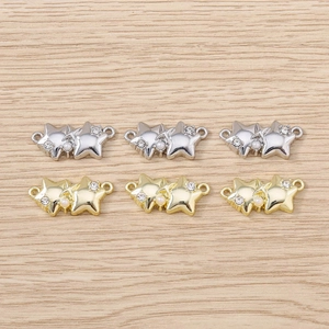 Close-up of star pendants with rhinestones and pearls in gold and silver finish