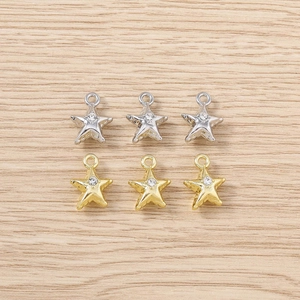Detail of star-shaped rhinestone pendants in gold and silver finish for DIY jewelry