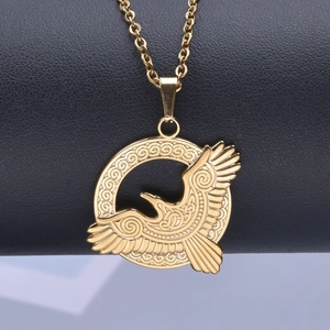 Detailed close-up of a golden eagle pendant with intricate Celtic knot patterns on a chain