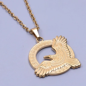 Detailed macro view of an eagle pendant in 18k gold plating with celtic spiral engravings