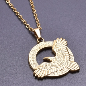 Detail of 18k gold plated stainless steel eagle pendant with intricate Celtic patterns