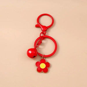 Detailed view of red flower keychain with metal lobster clasp and small bell charm