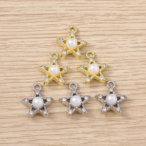 Macro view of gold and silver star pendants with pearls and rhinestones on wood