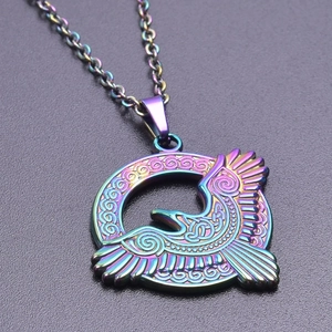 Macro detail of rainbow stainless steel eagle pendant with Celtic knotwork patterns