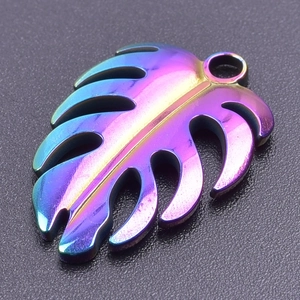 Detailed macro view of iridescent monstera leaf pendant in 18k plated stainless steel