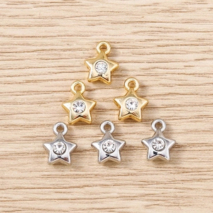 Macro shot of gold and silver star pendants with rhinestones for DIY jewelry making