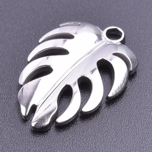 Detailed macro view of silver monstera leaf pendant with hollow design and polished finish