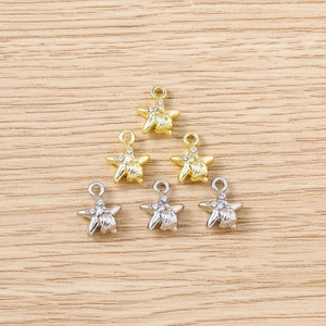 Detailed view of six rhinestone starfish charms in gold and silver for DIY jewelry making