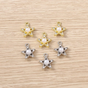 Detail of five-pointed star pendants with white pearls and sparkling rhinestones