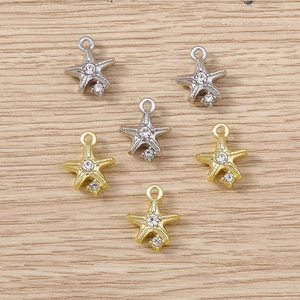 Detailed close-up of starfish pendants with sparkling rhinestones in gold and silver finish