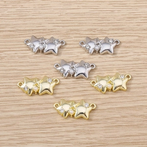 Detailed close-up of double star jewelry connectors with rhinestones and pearls for DIY
