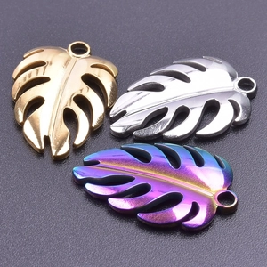 Macro view of monstera leaf pendants in gold silver and rainbow finishes for jewelry DIY