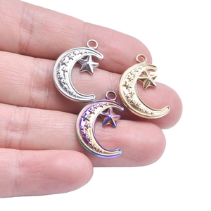Detail view of 18k gold plated moon and star charms for DIY jewelry making necklaces