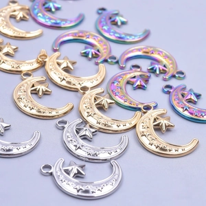 Detail view of 18k gold and silver moon star charms for DIY necklace making