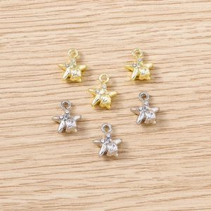 Macro shot of gold and silver star pendants with shell texture and inset crystals