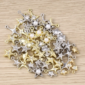 Detailed close-up of mixed gold and silver star pendants with rhinestones and pearls