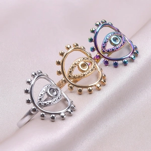 Detailed close-up of bohemian evil eye open rings in silver, gold and rainbow finishes