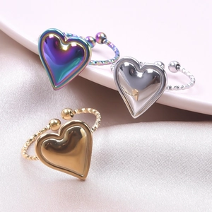 Macro detail of heart-shaped adjustable rings in silver, gold, and rainbow finishes